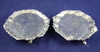 Two George II silver waiters, of shaped circular form, with decorated borders and one with