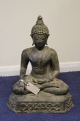 A South East Asian bronze seated figure of Buddha, on a scroll cast throne, 18in.