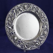A late Victorian silver dish by William Comyns, with pierced border decorated with masks, birds