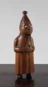 A European carved boxwood snuff box, modelled as a standing religious figure with glass eyes and