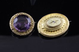 A Victorian gold and diamond set oval brooch, 1.25in and a gold and amethyst set circular brooch,