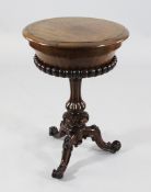 A Victorian mahogany circular work table, the hinged top opening to reveal a velvet lined interior