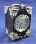 A late 19th/early 20th century silver mounted tortoiseshell carriage clock, with pierced silver