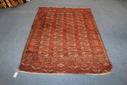 A 1920`s Bokhara rug, with field of forty eight octagons, on a madder ground, with geometric border,