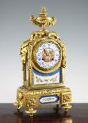 A 19th century French ormolu and Sevres style porcelain mantel clock, with urn surmount and mask