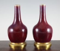 A pair of Chinese flambe bottle vases, 19th century, the bases with 19th century European bronze