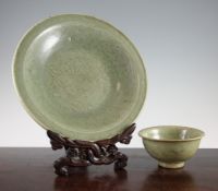 A Chinese Longquan celadon dish and a similar bowl, Ming dynasty, the centre carved with a flower