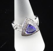 A 14ct white gold, tanzanite and diamond cluster dress ring, with triangular setting and overlapping