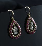 A pair of gold, foil backed ruby and diamond set drop earrings, of pear form, 0.75in.