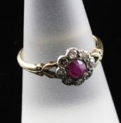 A late 19th/early 20th century 18ct gold ruby and diamond cluster ring, of flowerhead design, the