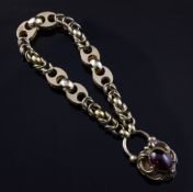 A Victorian gold fancy link bracelet, with cabochon garnet set heart shaped locked with glazed back,