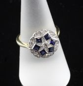 An Art Deco style 18ct gold, sapphire and diamond cluster ring, of circular form, with pierced