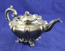 An early Victorian silver melon shaped teapot by The Barnards, with acanthus leaf capped handle