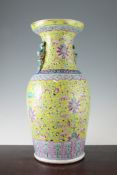 A Chinese famille rose yellow ground vase, 20th century, painted with lotus flowers and leaf