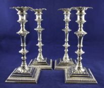 A set of four George III silver candlesticks by William Cafe, with turned stems and fluted whorl