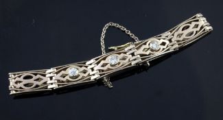 A 9ct gold and three stone diamond set fancy bar link bracelet, gross 11.1 grams.