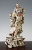A Japanese polychrome wood figure of a temple guardian, Edo period, the standing figure holding a