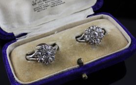 A pair of Victorian 18ct white gold and diamond cluster rings, of flowerhead design, each set with