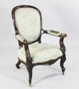 A Victorian carved oak armchair, with padded back, arms and seats, on floral carved cabriole legs