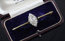 An early 20th century gold and diamond bar brooch, the central marquise set motif set with fifteen