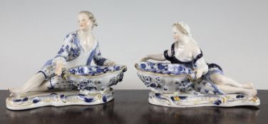 Two Meissen figural salts, late 19th century, each decorated in blue and white and gilt, the