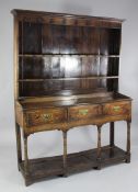 An 18th century oak dresser, the plate rack back with iron cup hooks above three frieze drawers