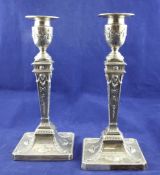 A pair of late Victorian Adam design silver candlesticks, of square tapering form, decorated with