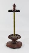 A 19th century mahogany and brass revolving snooker cue stand, with circular platform base and bun