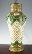 A large Sevres style porcelain and ormolu mounted baluster lamp base, gilded with trophy reserves