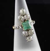 An early 20th century gold and platinum, emerald and diamond set up-finger dress ring, with