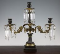 A 19th century French bronze and ormolu three branch candelabrum, with cut glass pendant lustre