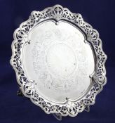 A Victorian silver salver, of shaped circular form, with pierced and wavy foliate scroll border,