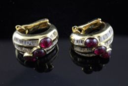 A stylish pair of gold, cabochon ruby and baguette cut diamond set semi circular earclips.