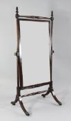 A Regency mahogany cheval mirror, with rectangular mirror plate, with downswept supports and brass