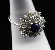 A white gold, sapphire and diamond cluster ring, size K.