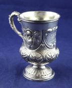 A George IV silver pedestal christening mug, of vase form, with embossed floral and foliate