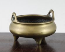 A Chinese bronze censer, 18th/19th century, the compressed globular body with a pair of high