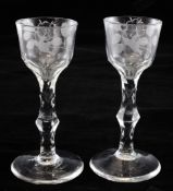 A pair of facet stem wine glasses, c.1785, the ogee bowls engraved with floral sprays and a bird