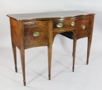 A George III mahogany boxwood strung serpentine sideboard, with central drawer between two