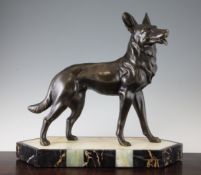 A French Art Deco patinated metal figure of a standing Alsatian, on a hexagonal onyx and marble