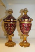 A pair of Bohemian ruby and citrine glass goblets and covers, late 19th century, each with gilt