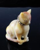 A gem set hardstone figure of a seated cat, with diamond set eyes and bow and cabochon ruby