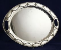 A George V silver oval tea tray, with harebell swag border and inset handles, on bun feet, R.F.