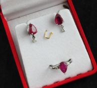 A white gold, ruby and diamond suite of jewellery, comprising ring and pair of earrings, all set