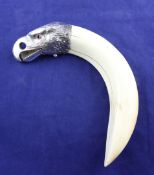 An early 20th century Austrian novelty silver mounted tusk cigar cutter modelled as an eagle`s
