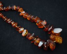 A single strand free form amber bead necklace, 34in.