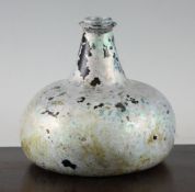 A green glass onion shaped bottle, early 18th century, with saturn ring neck, sand disc pontil and