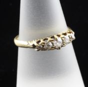 An 18ct gold and graduated five stone diamond half hoop ring, size O.