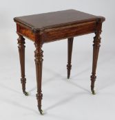 An unusual Victorian mahogany games table, the folding top opening to reveal a baize lined