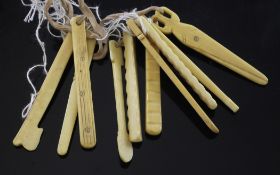 A collection of ten 19th century carved ivory teething tools, including scissors, saw, spoon and